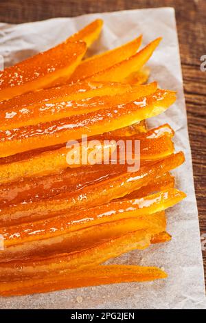 Candied orange peels on wrinkled baking paper. Stock Photo