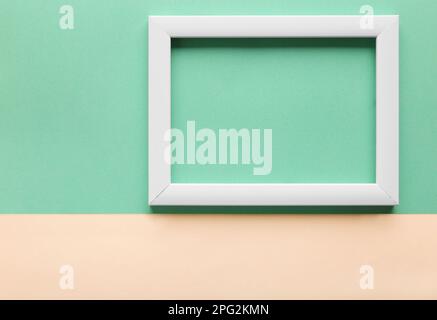White frame on a green background, top view. Minimalism. Business plan, planning for the month. Place for the image. Stock Photo