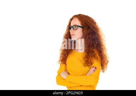 Head shot studio portrait young serious red-headed woman wearing blue t-shirt glasses looking at camera pose on grey white blank, spectacles eyewear o Stock Photo