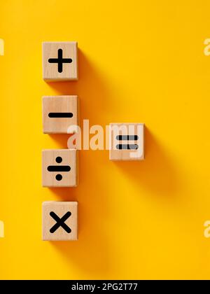 Basic mathematical operations symbols. Plus, minus, multiply, divide and equal symbols on wooden cubes. Mathematic or math education and basic calcula Stock Photo