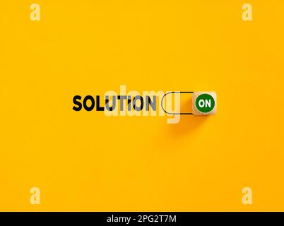 Solution on slider button on yellow background. To find a solution for problems concept. Stock Photo