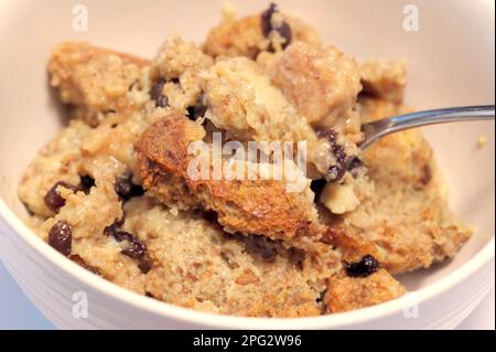 Homemade Bread Pudding with raisins in a bowl with spoon. Stock Photo