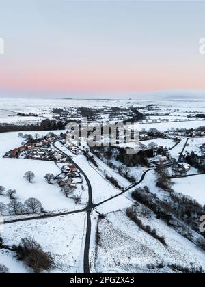 GOATHLAND, NORTH YORKSHIRE, UK - MARCH 10, 2023.  An aerial landscape view of the North Yorkshire Moors village of Goathland covered in snow Stock Photo