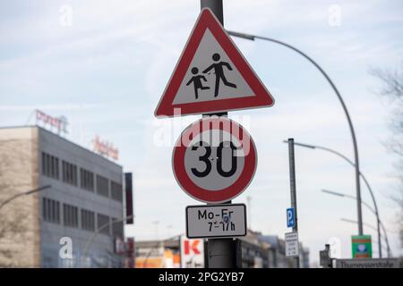 Berlin, Germany. 18th Mar, 2023. A Attention Children and a Speed 30 sign with an additional sign for the speed limit at certain times. Credit: Paul Zinken/dpa/Alamy Live News Stock Photo