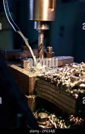 the work of a drill on a metal workpiece at the factory Stock Photo