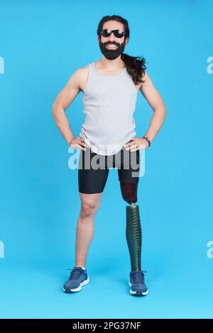 Smiley man with sunglasses standing with a prosthetic leg Stock Photo