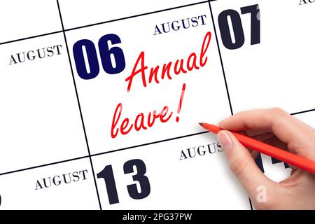 6th day of August. Hand writing the text ANNUAL LEAVE and drawing the sun on the calendar date August 6. Save the date. Time for the holidays. vacatio Stock Photo