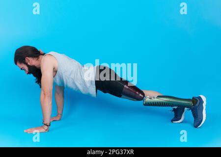 Man with a prosthetic leg doing push ups Stock Photo
