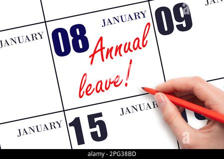 8th day of January. Hand writing the text ANNUAL LEAVE and drawing the sun on the calendar date January 8. Save the date. Time for the holidays. vacat Stock Photo