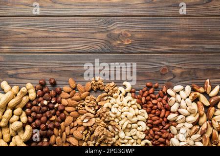 different nuts frame background. Close up, top view, flat lay with vopy space. Walnut, pistachios, almonds, hazelnuts and cashews. Stock Photo