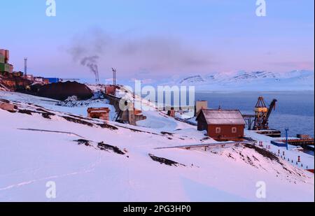 Storage of the coal from the mine. Russian coal mining town Barentsburg at fjord Groenfjorden, Svalbard. The coal mine is still in operation. Arctic R Stock Photo