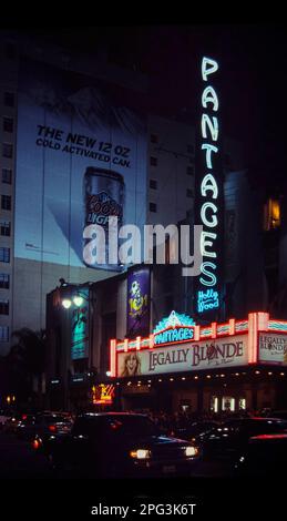 Night view of the Pantages theater, lit up with neon lights, with a performance of Legally Blonde. Coor's light advert in the background. Stock Photo