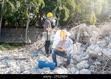 Demolition control supervisor and contractor working on demolish building. Stock Photo