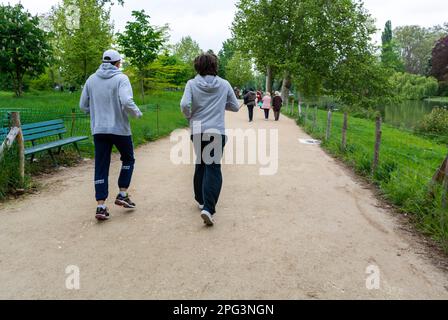 Paris, France, Couple Young Adults, Joggers Running away in French Park, couple running (Bois de VIncennes) Stock Photo