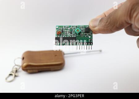 Wireless remote control receiver circuit held in the hand Stock Photo