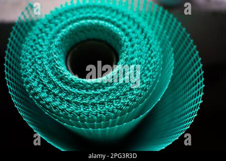 New roll of green reinforcing mesh close-up. Plaster mesh for wall screed Stock Photo