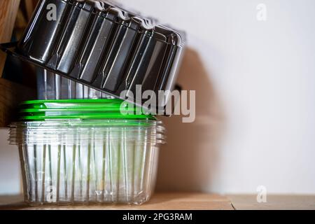 Various plastic containers after products are sorted and stacked in one place, close-up. Recycling plastic containers after shopping in the store Stock Photo