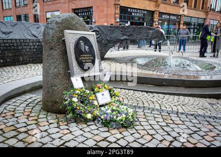 20 March 2023 - Warrington, Cheshire; The 30th anniversary of the Warrington bombings took place in the Town Centre with a service at Market Gate and a minutes silence by The River of Life, a feature in Bridge Street as a memory of the tragic day. Wreaths have been placed at the Commemoration Plaque by The River of Life Stock Photo
