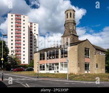 Harwood House high rise tower block stands behind St Luke's Church and community hall on the Barton Hill Estate in Bristol. Stock Photo