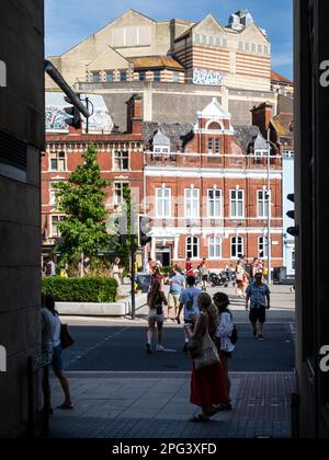 Pedestrians walk along Colston Avenue in Bristol City Centre, with Bristol Crown Court complex rising in the background. Stock Photo