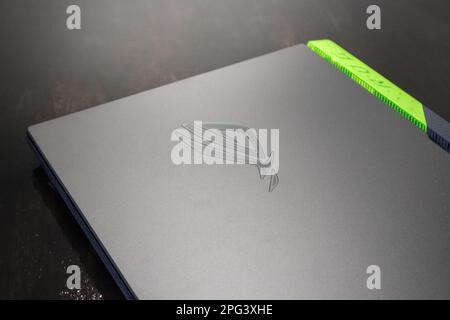 Kiev, Ukraine - August 28, 2022: ROG Strix G17 (Republic of Gamers) Gaming Laptop by ASUS close-up on table. Gaming grey notebook on black. Tech, IT, Stock Photo