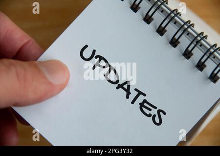Top view of Update text on white notepad. Business update concept Stock Photo