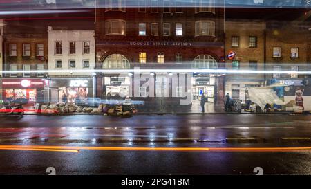 Goodge Street Station is seen through the lights of passing traffic on Tottenham Court Road in central London. Stock Photo
