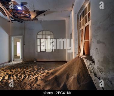 Kolmanskop (Afrikaans for Coleman's hill, German: Kolmannskuppe) is a ghost town in the Namib desert in southern Namibia, a few kilometres inland from Stock Photo