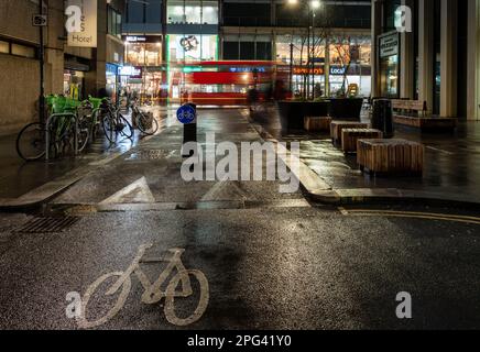 A 'modal filter' bollard protects a cycle lane on Beford Avenue, part of a traffic reduction and public realm improvement scheme on Tottenham Court Ro Stock Photo