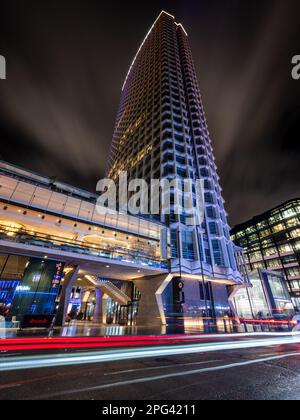 Traffic leaves light trails on New Oxford Street outside the Centrepoint skyscraper in central London. Stock Photo