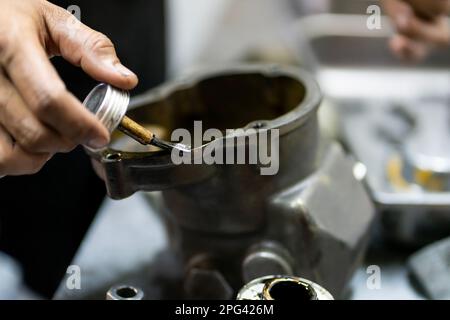 Close-up photos of assembling engine parts or machines that have components that are springs by skilled technicians. Stock Photo