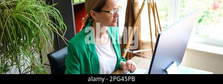 Smiling business woman working on compute in office Stock Photo