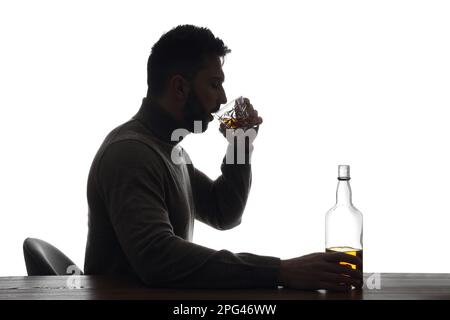 Silhouette of addicted man drinking alcohol on white background Stock Photo