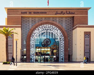 Marrakech, Morocco - January 02, 2020: Ornaments decorating walls of Marrakesh railway station, sun shines on pavement leading to large glass entrance Stock Photo