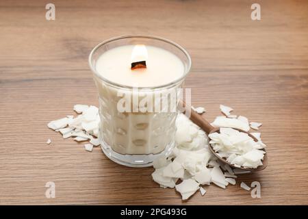 Wooden spoon and soy wax flakes on light blue background, flat lay with  space for text. Homemade candle material Stock Photo - Alamy