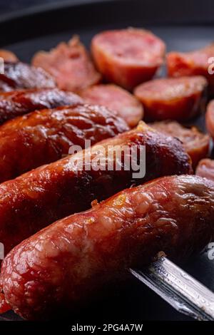 A row of assorted sausages on a skewer Stock Photo