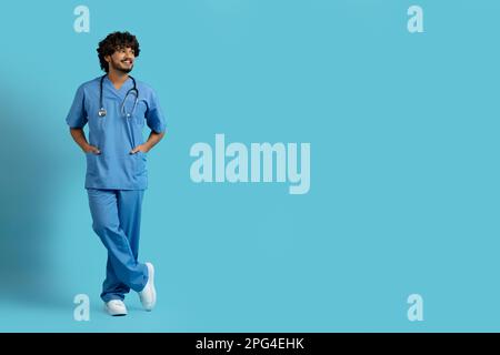 Cheerful handsome young indian man in medical workwear surgeon Stock Photo