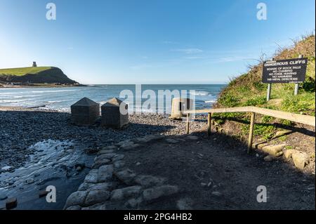 Entrance to Kimmeridge bay beach with WW2 anti tank blocks, type 25 pillbox looking out to sea on a sunny morning with clear blue sky. Isle of Purbeck Stock Photo