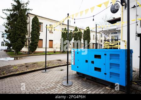Ivano-Frankivsk, Ukraine - March, 2023: Blue diesel generator on street near cafe. Stock Photo