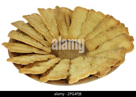 handmade speculoos cookies on a wooden plate isolated on white background Stock Photo