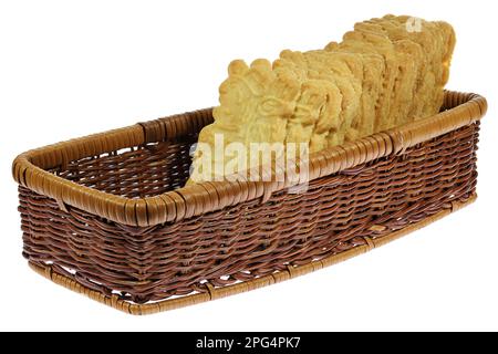 handmade speculoos cookies in a rattan basket isolated on white background Stock Photo