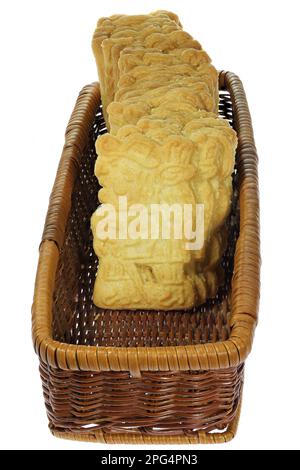 handmade speculoos cookies in a rattan basket isolated on white background Stock Photo