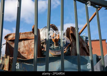 Rusty scrap metal for recycling behind a fence in Kyläsaari district of Helsinki, Finland Stock Photo