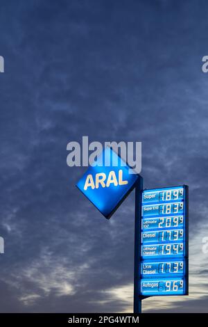 Neuhausen, Germany - February 19, 2022: Price display in front of a dramatic dark sky at dawn. High and expensive fuel prices in europe. Aral. Stock Photo