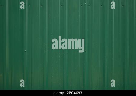 Close up green metal corrugated siding background Stock Photo