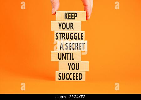 Keep secret symbol. Concept words Keep your struggle a secret until you succeed on wooden blocks. Beautiful orange background. Copy space. Businessman Stock Photo