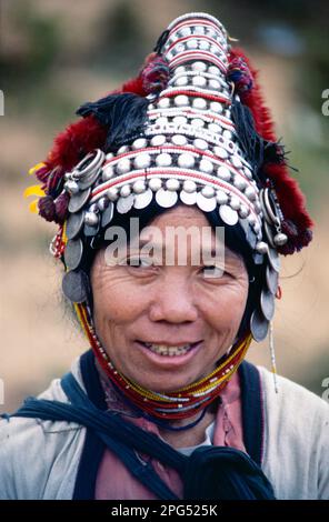Thailand. Chiang Rai. Akha people. Portrait of tribeswoman in traditional headdress. Stock Photo
