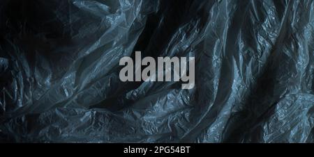 Dark gray plastic wrap background. Crumpled wrinkled plastic cellophane. Texture overlay effect template Stock Photo