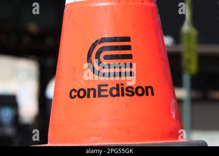 New York, NY - March 19, 2023: Orange construction cone with gas and electric utility provider ConEdison name, corporate logo close on city street Stock Photo