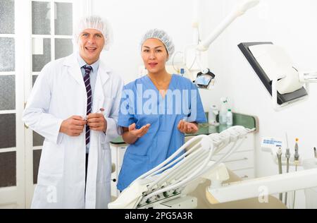 Dentist with assistant at the dental office Stock Photo